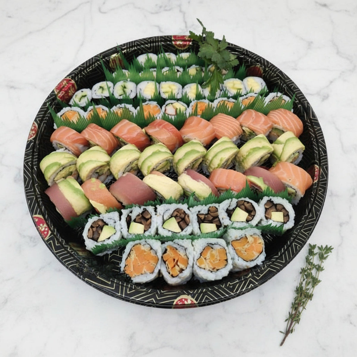 Overhead view of a 48 piece medium maki platter on a black catering tray on a marble surface