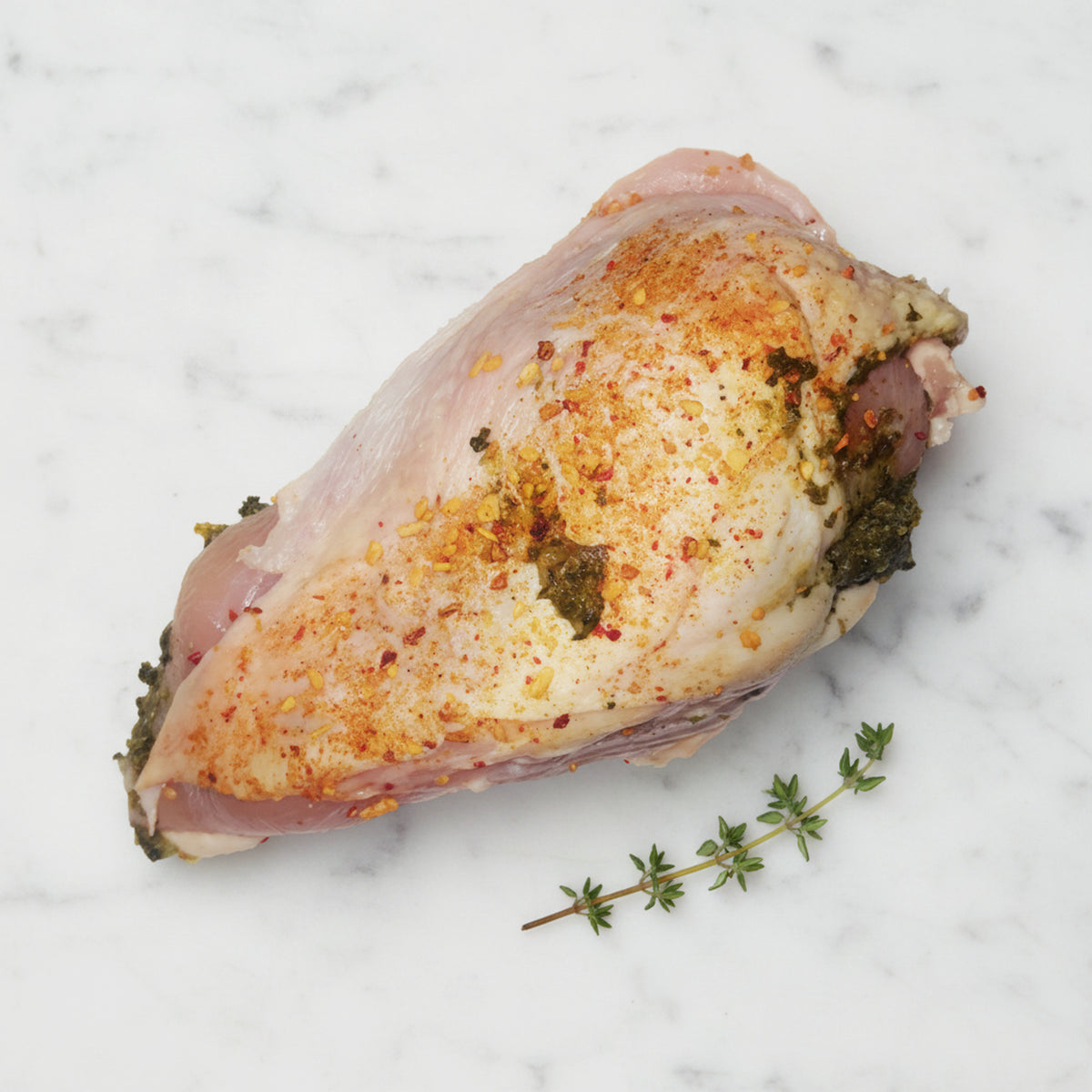 Boneless chicken breast stuffed with spinach and mushroom on a white marble surface