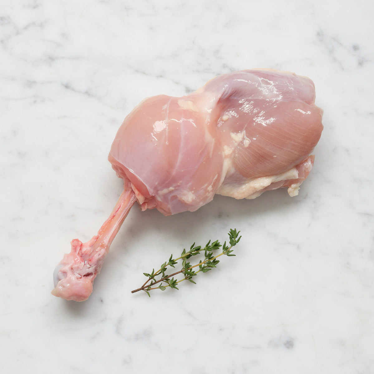 Raw chicken steak on a white marble surface