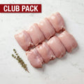 Club Pack of eight raw boneless, skinless chicken legs in two rows with thyme on white marble
