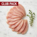 Club Pack of thin raw chicken cutlets fanned in a curve with thyme on white marble