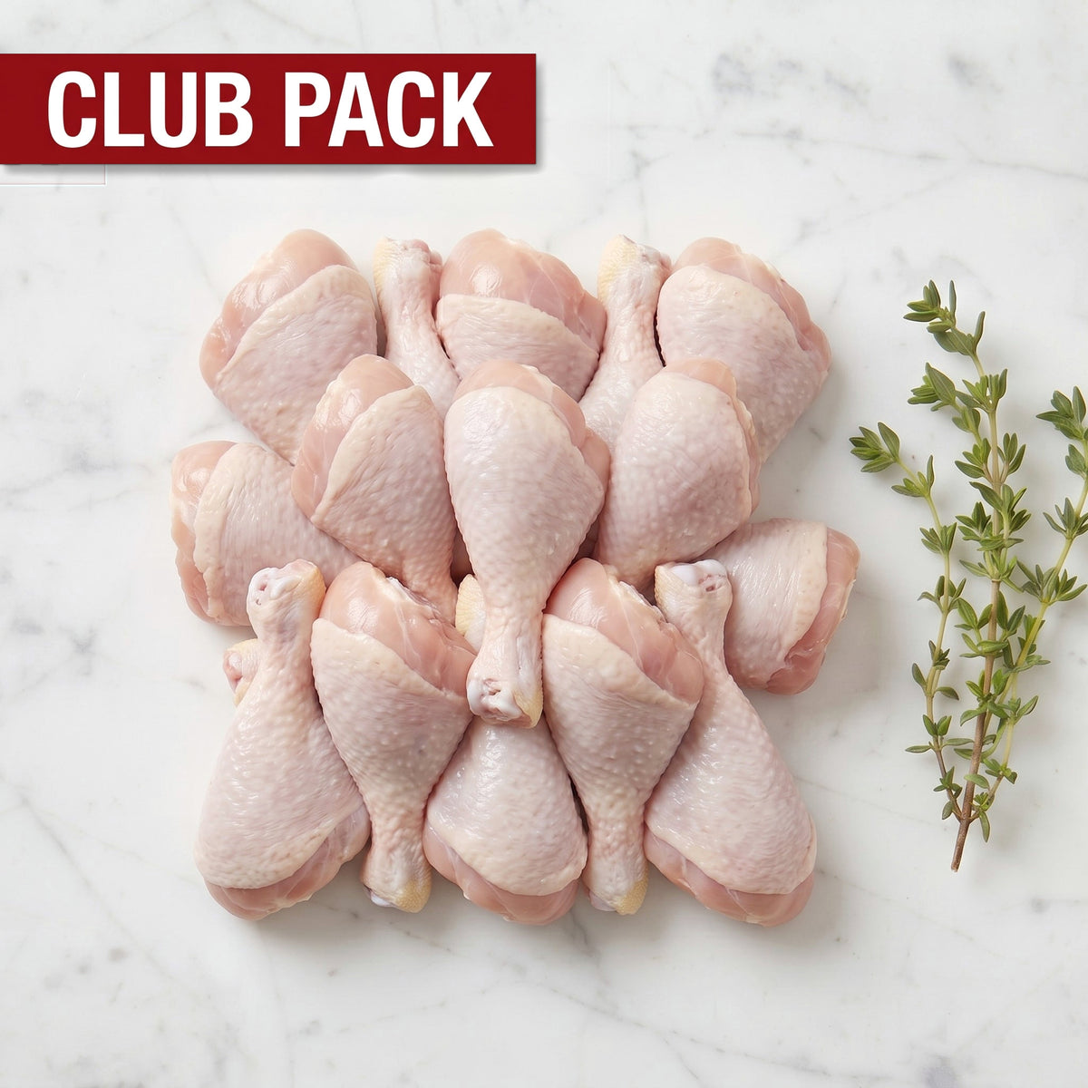 Club Pack of raw chicken drumsticks arranged in a block with thyme on white marble