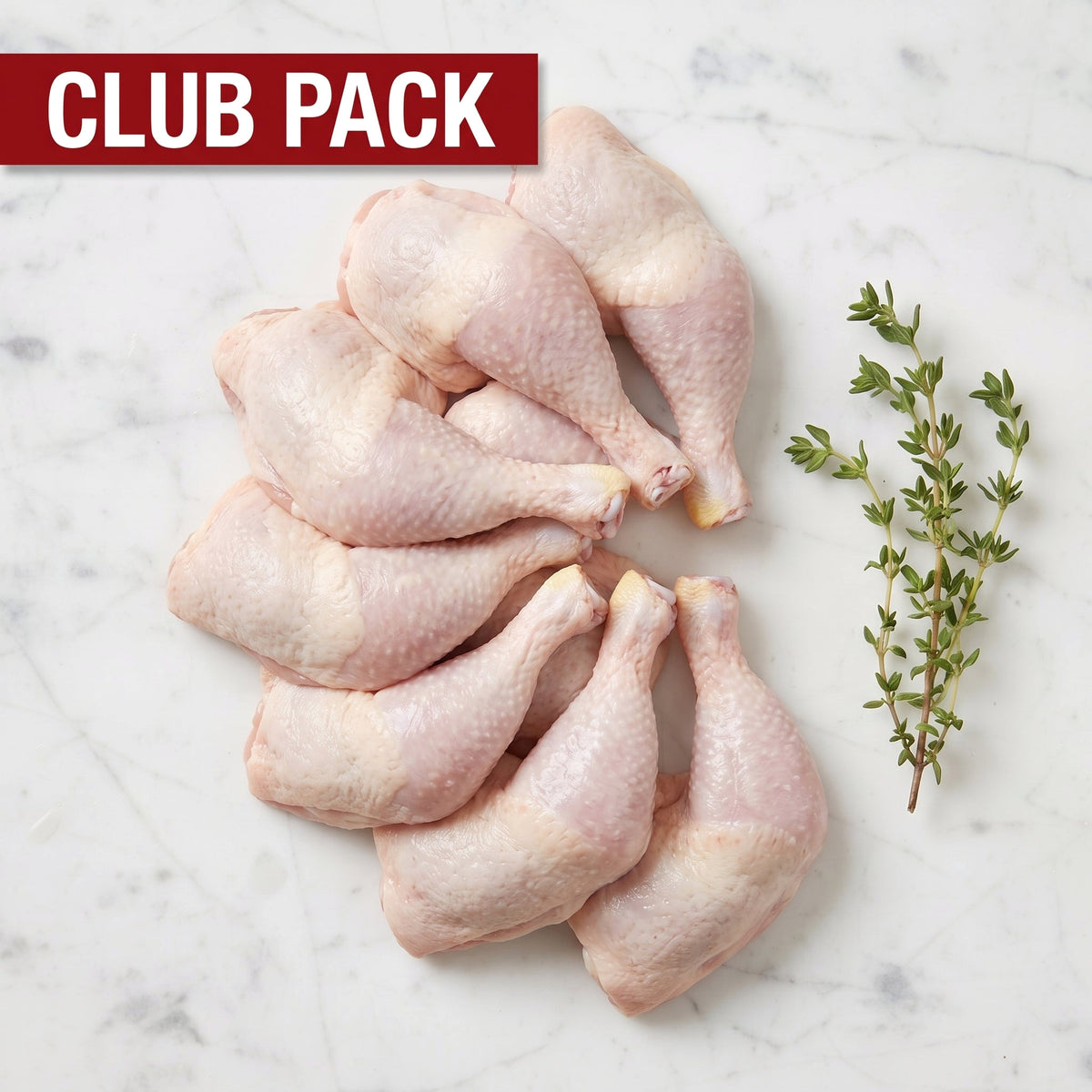 Club Pack of raw bone-in chicken legs, thigh and drumstick attached, with thyme on white marble