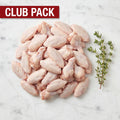 Club Pack of raw chicken wing flats and drumettes piled with thyme on white marble