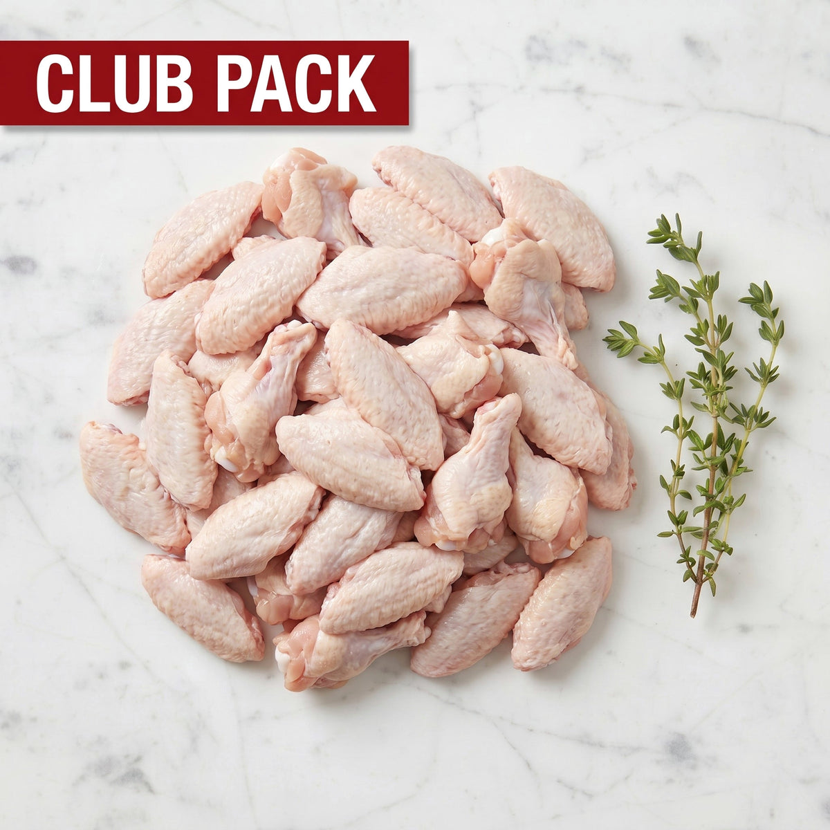 Club Pack of raw chicken wing flats and drumettes piled with thyme on white marble