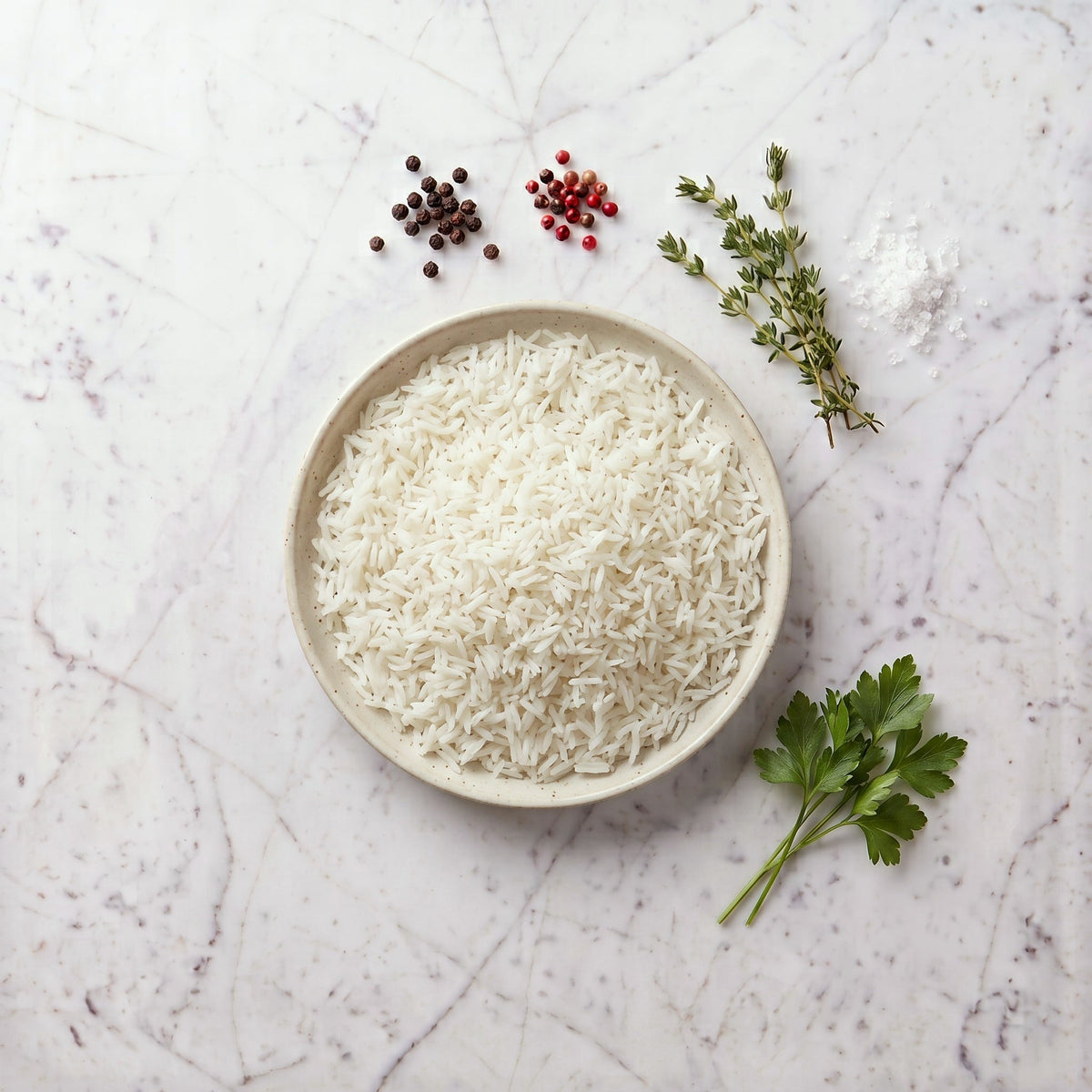 Overhead view of a bowl of plain white rice on a marble surface