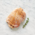 Boneless chicken thighs stuffed with kishka on a white marble surface