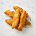 Overhead view of five TK Breaded Chicken Tenders with thyme on a marble surface