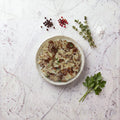 Overhead view of a bowl of TK Kasha and Bows, bowtie pasta with buckwheat and onion gravy
