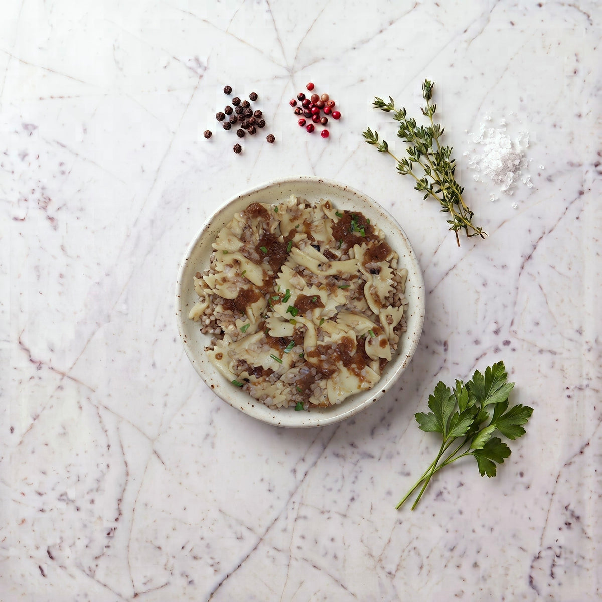 Overhead view of a bowl of TK Kasha and Bows, bowtie pasta with buckwheat and onion gravy