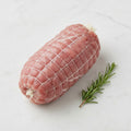 TK dark meat turkey roll on a white marble surface